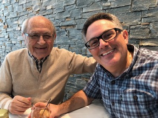 Naim and Ghassan smile next to each other.